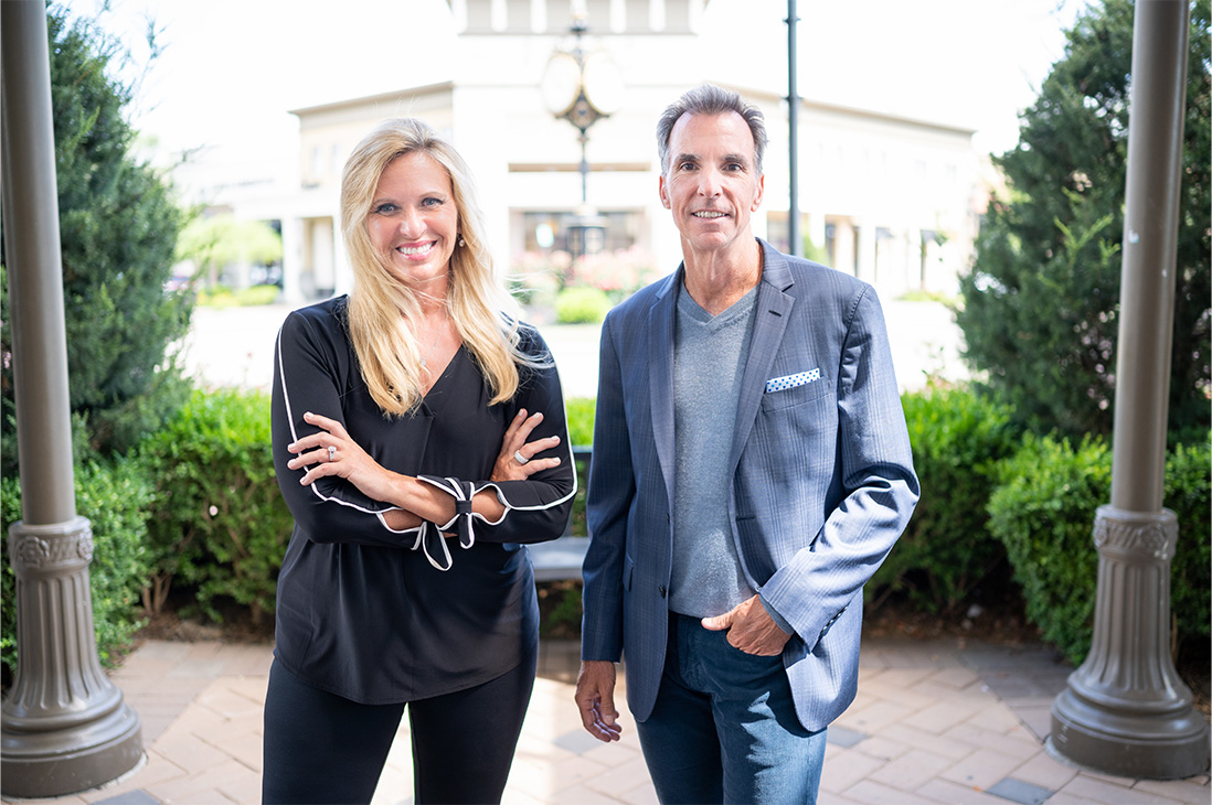 Image of digital marketing agency owners Deb Rishel and Bob Newman standing outside Paradigm Digital Group offices