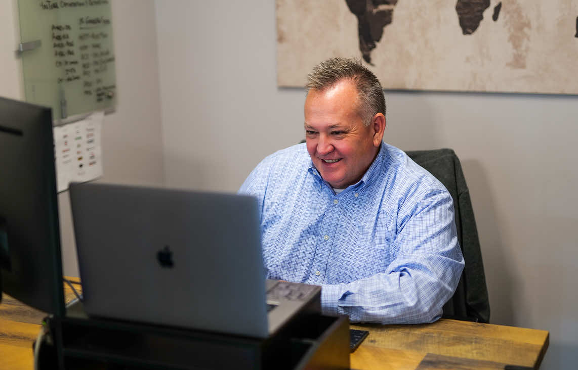 Image of Vice President of Marketing Mike Curts working on Reporting analytics for clients at Paradigm Digital Group offices