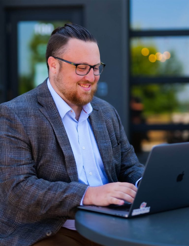 Image of Digital Strategist Lawson Hearne working on Reporting spreadsheets for clients at Paradigm Digital Group offices