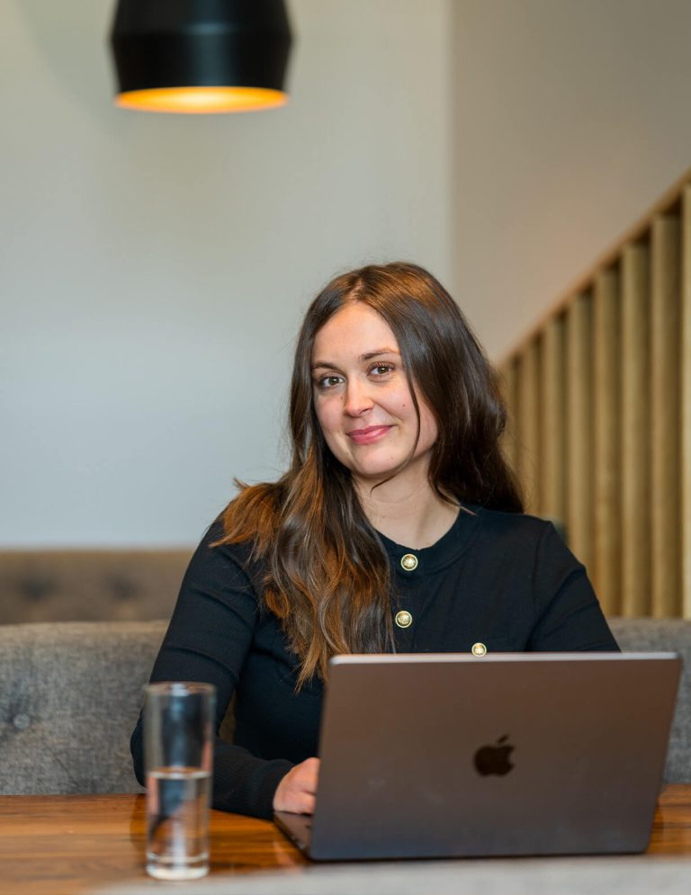 Image of digital intern Evie Hoeg with laptop at Paradigm Digital Group offices