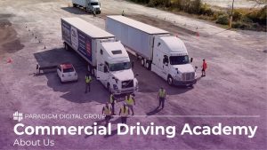 Image of two parked semi trucks with six truck drivers wearing high-reflective vests walking around with text reading "Commercial Driving Academy: About Us"