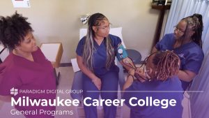 Image of patient sitting on examiner table with two nurses taking vitals and an instructor watching with text reading "Milwaukee Career College: General Programs"