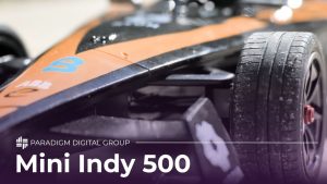Image of a close-up of a remote control race car with text reading "Mini Indy 500"