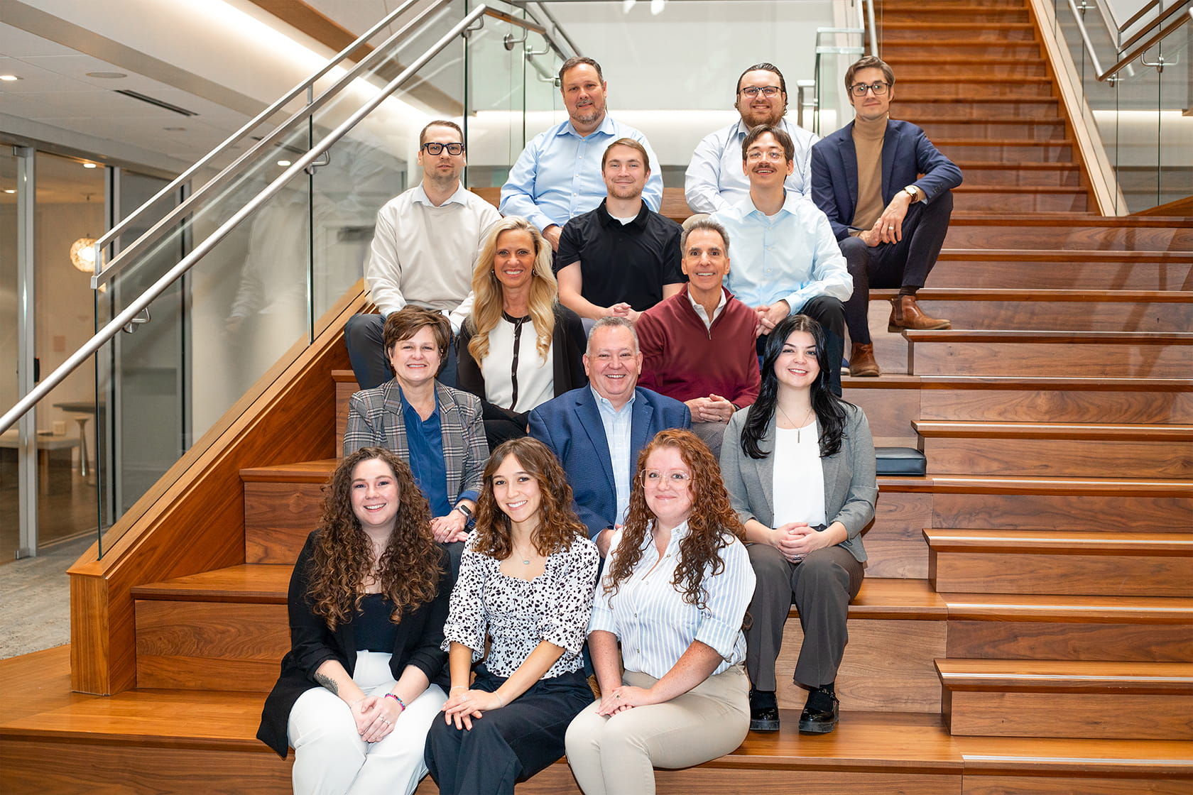 Paradigm Digital Group team sitting on stairs in office building