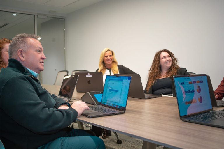 Mike, Destiny, Deb sitting at conference table, looking forward