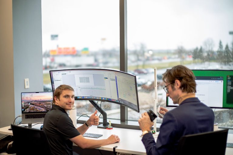 Sam smiling and giving a thumbs up, Evan cleaning camera lense