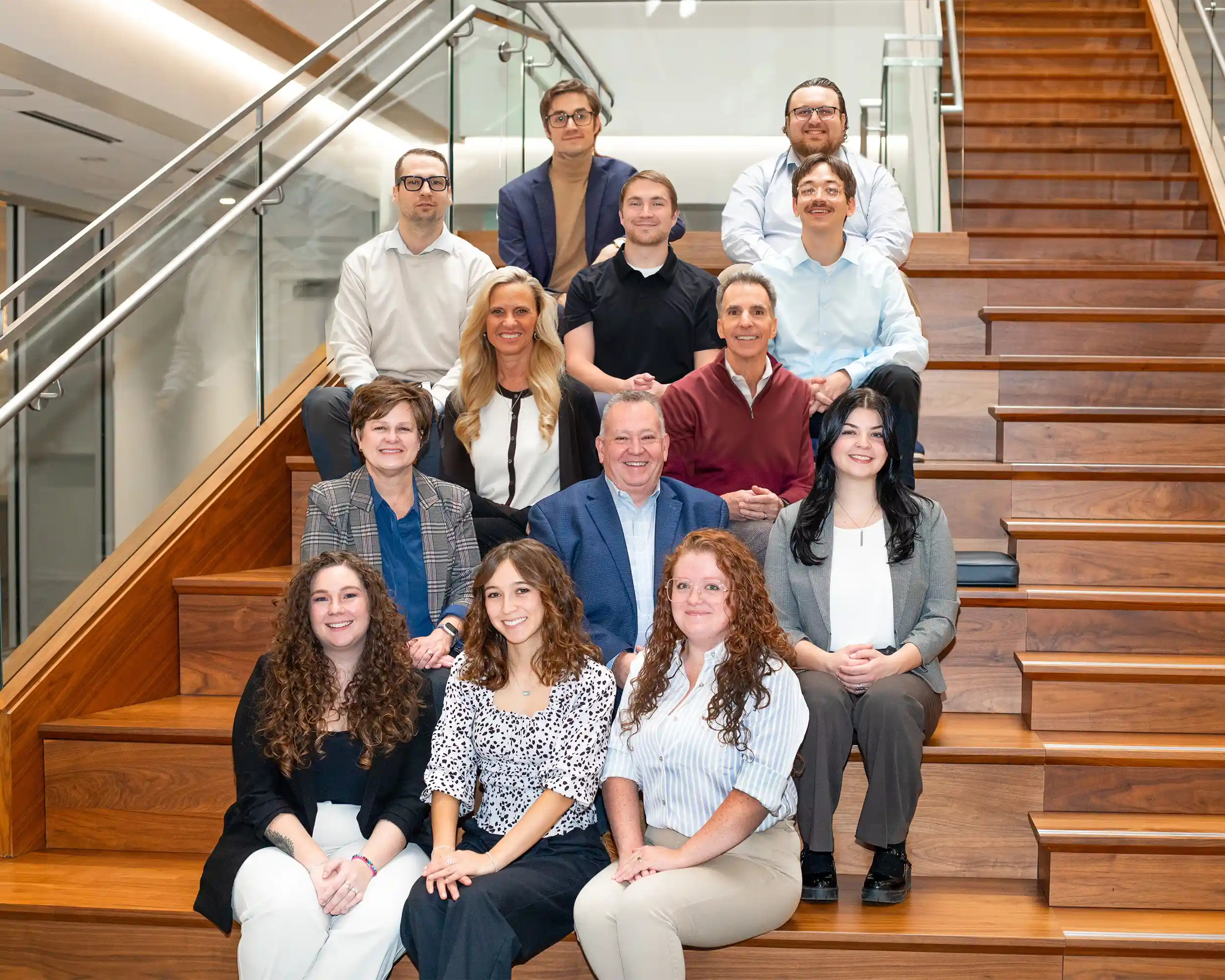 Paradigm Digital Group team sitting on stairs in office building