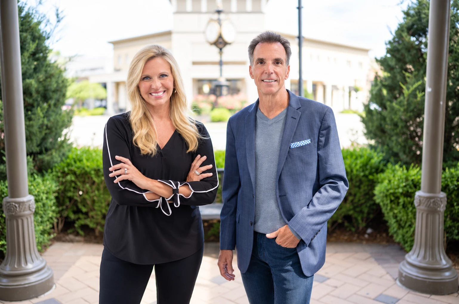 Bob and Deb smiling and standing together in front of a building